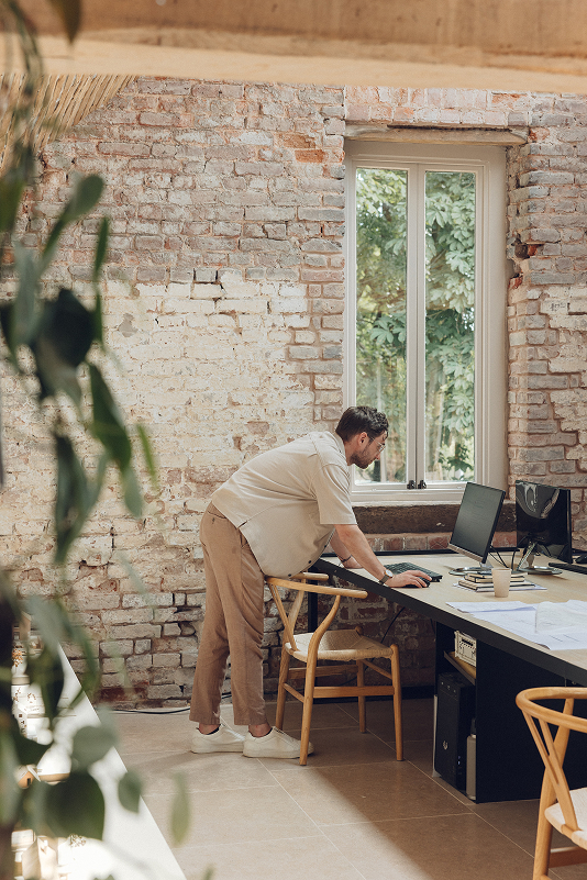 Designer working at a drawing desk in the studio workshop