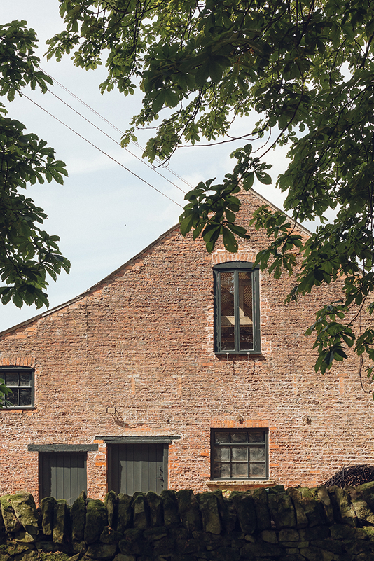 White-painted country barn with glazed workshop doors