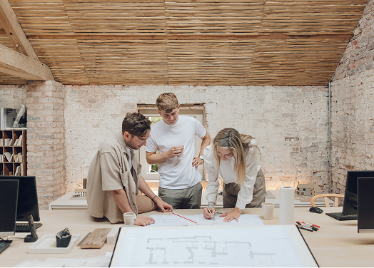 Studio team reviewing drawings